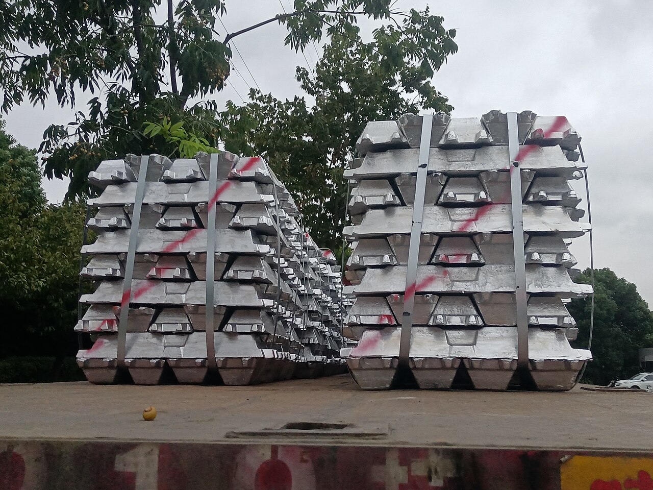 Aluminium ingots loaded on a truck, handling and logistics context