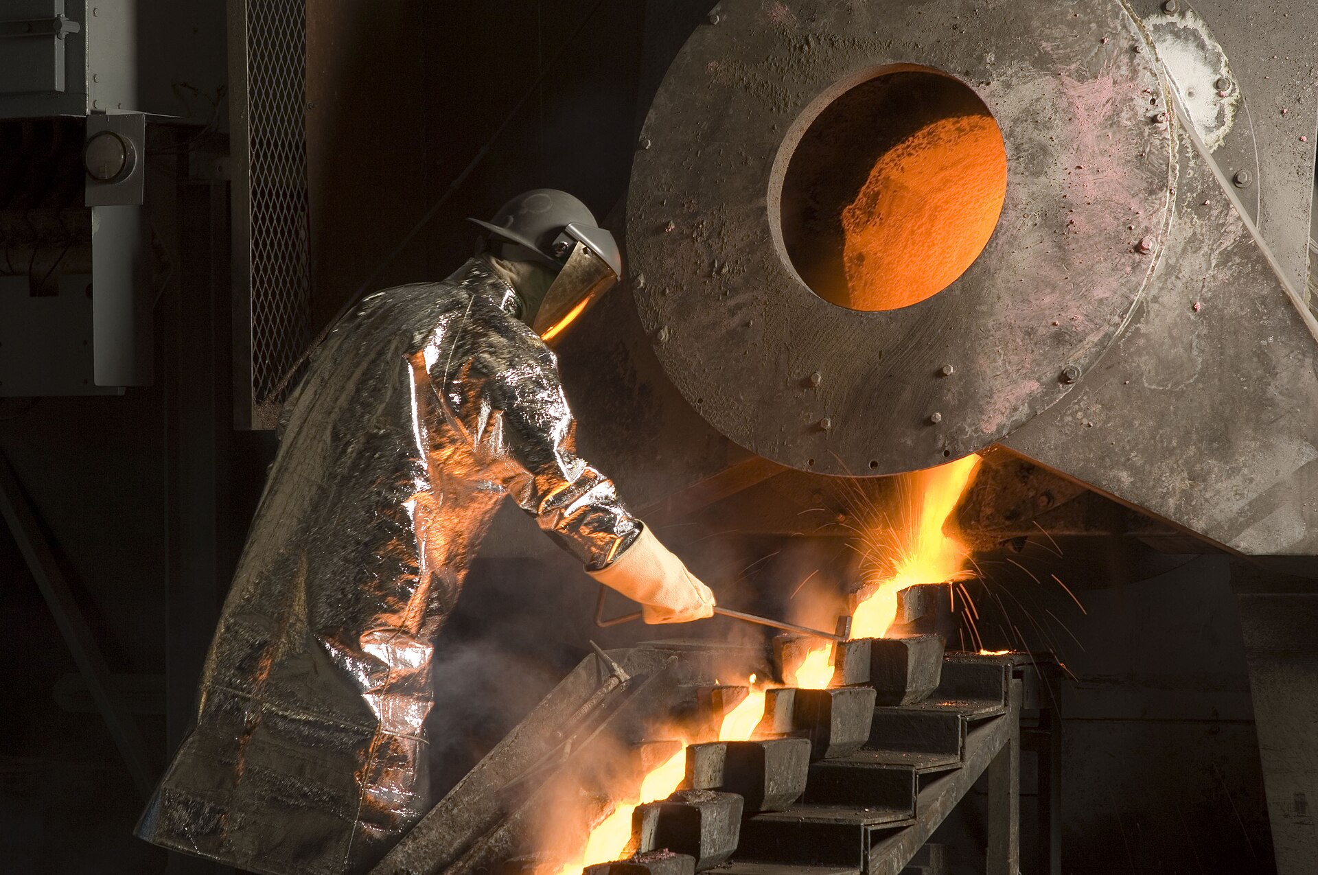 Molten gold poured into moulds in a mining environment, industrial context for doré